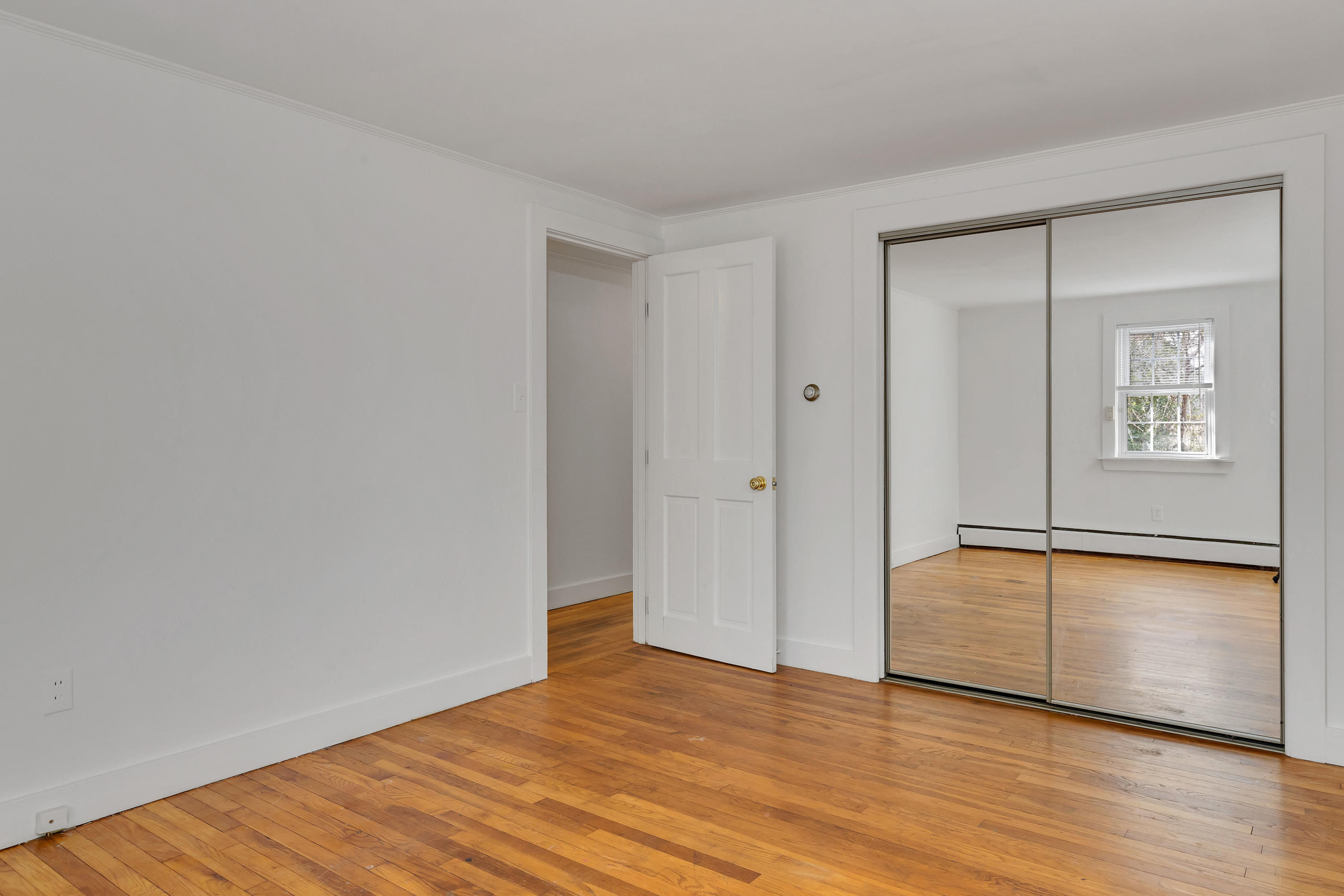 54 Murphy Road Hyannis, MA 02601 - Photo 14 of 24 a view of an empty room with wooden floor and a window