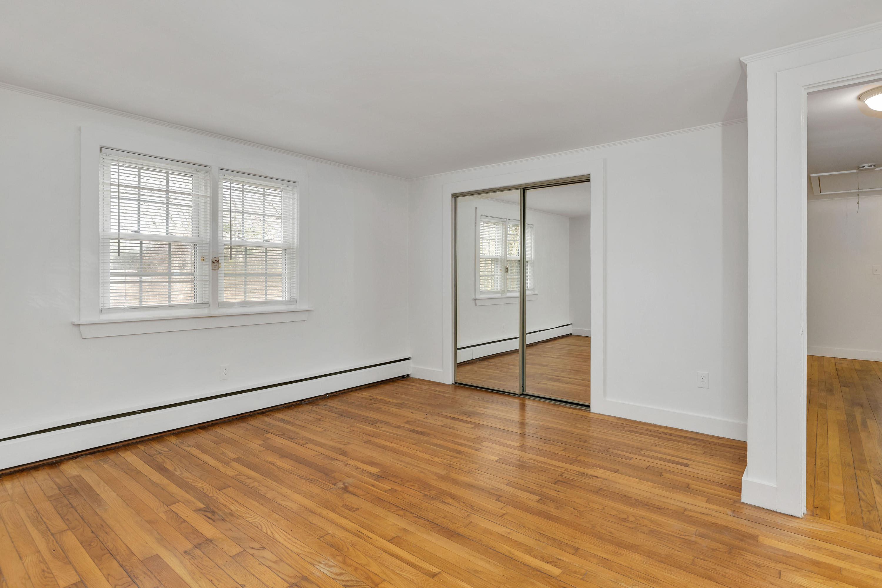 54 Murphy Road Hyannis, MA 02601 - Photo 17 of 24 an empty room with wooden floor and windows