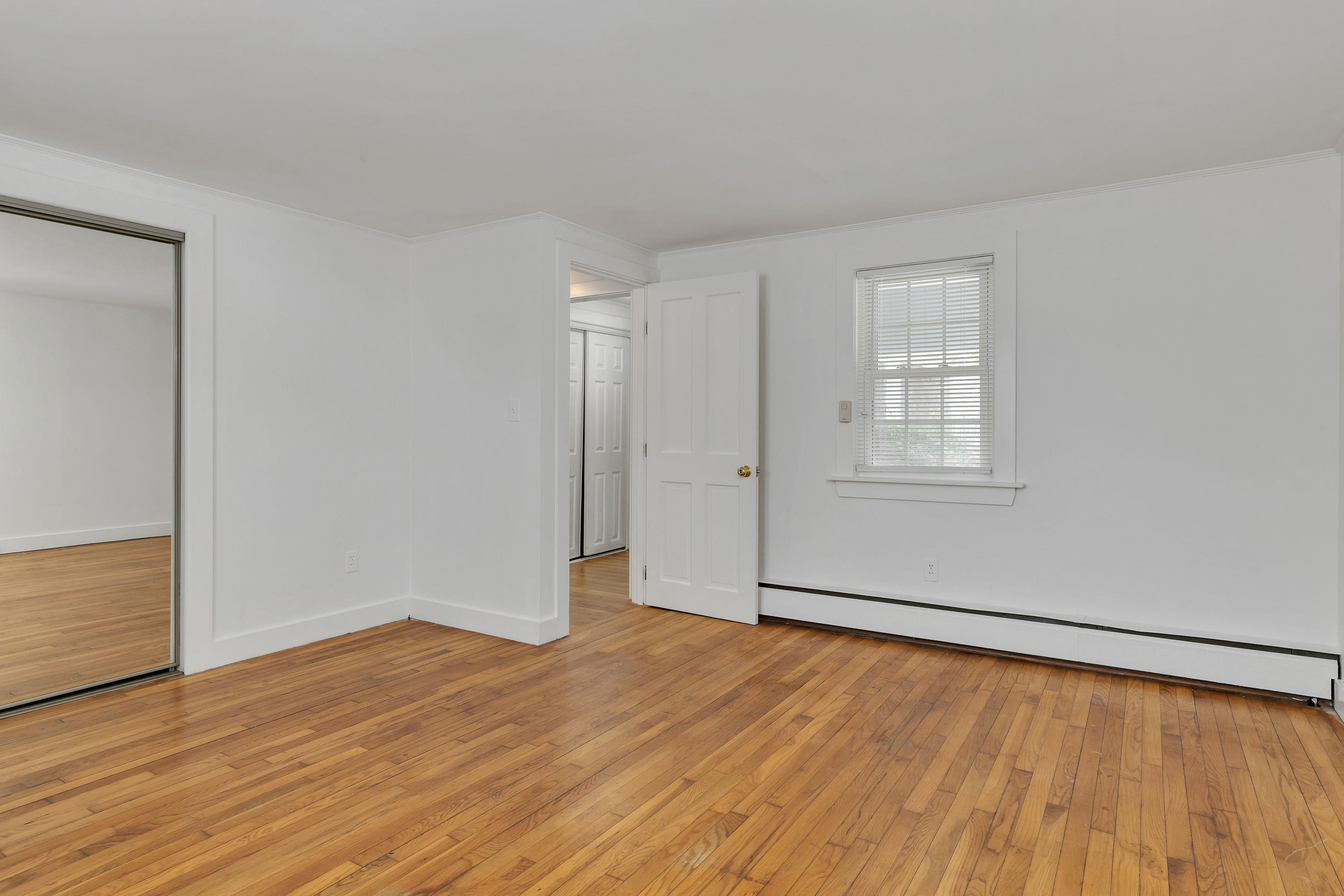 54 Murphy Road Hyannis, MA 02601 - Photo 18 of 24 an empty room with wooden floor and windows