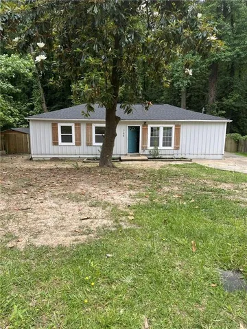 a house that has a tree in front of the house