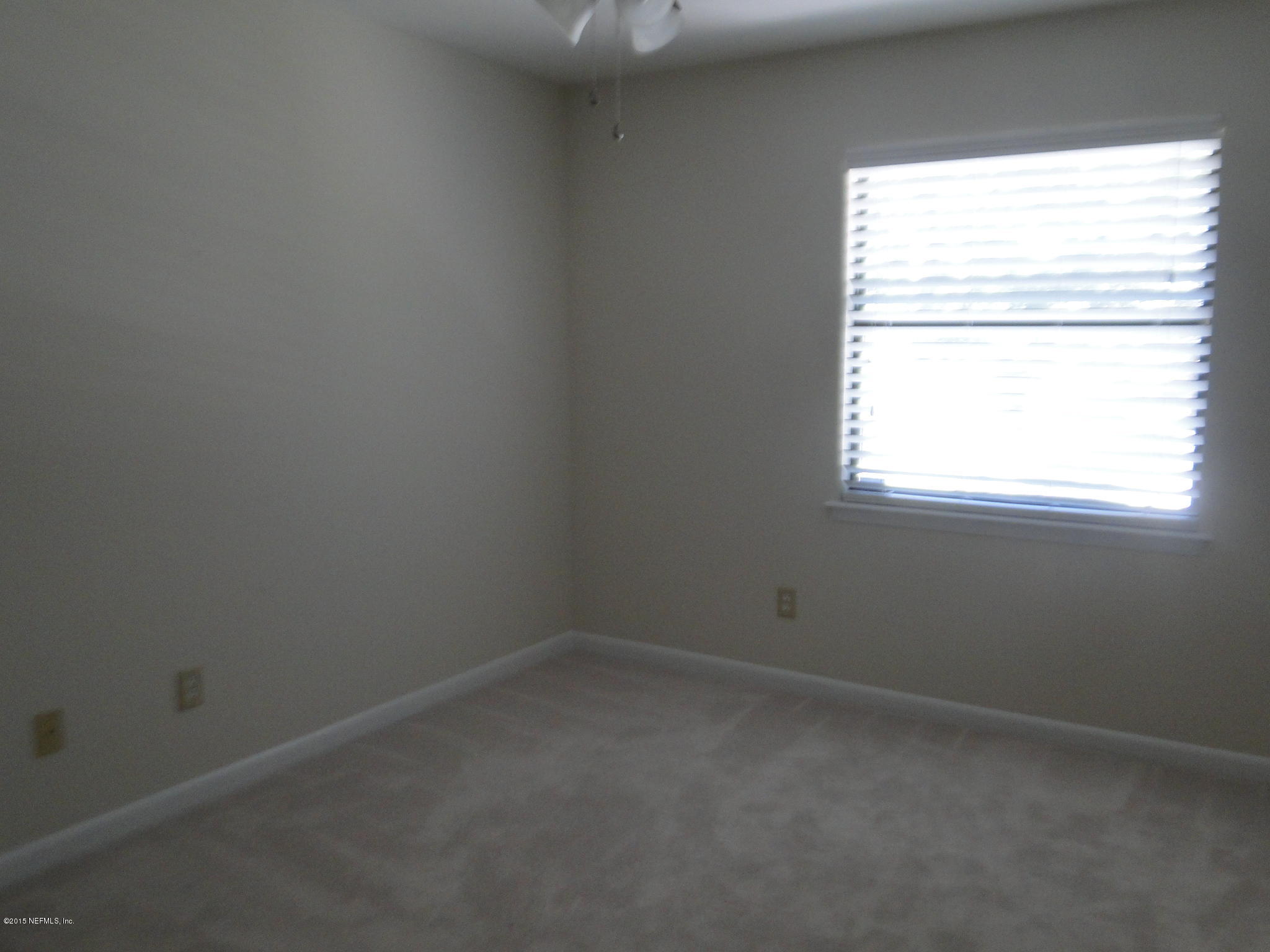 5496 Spring Brook Road Jacksonville, FL 32277 - Photo 24 of 25 an empty room with a window