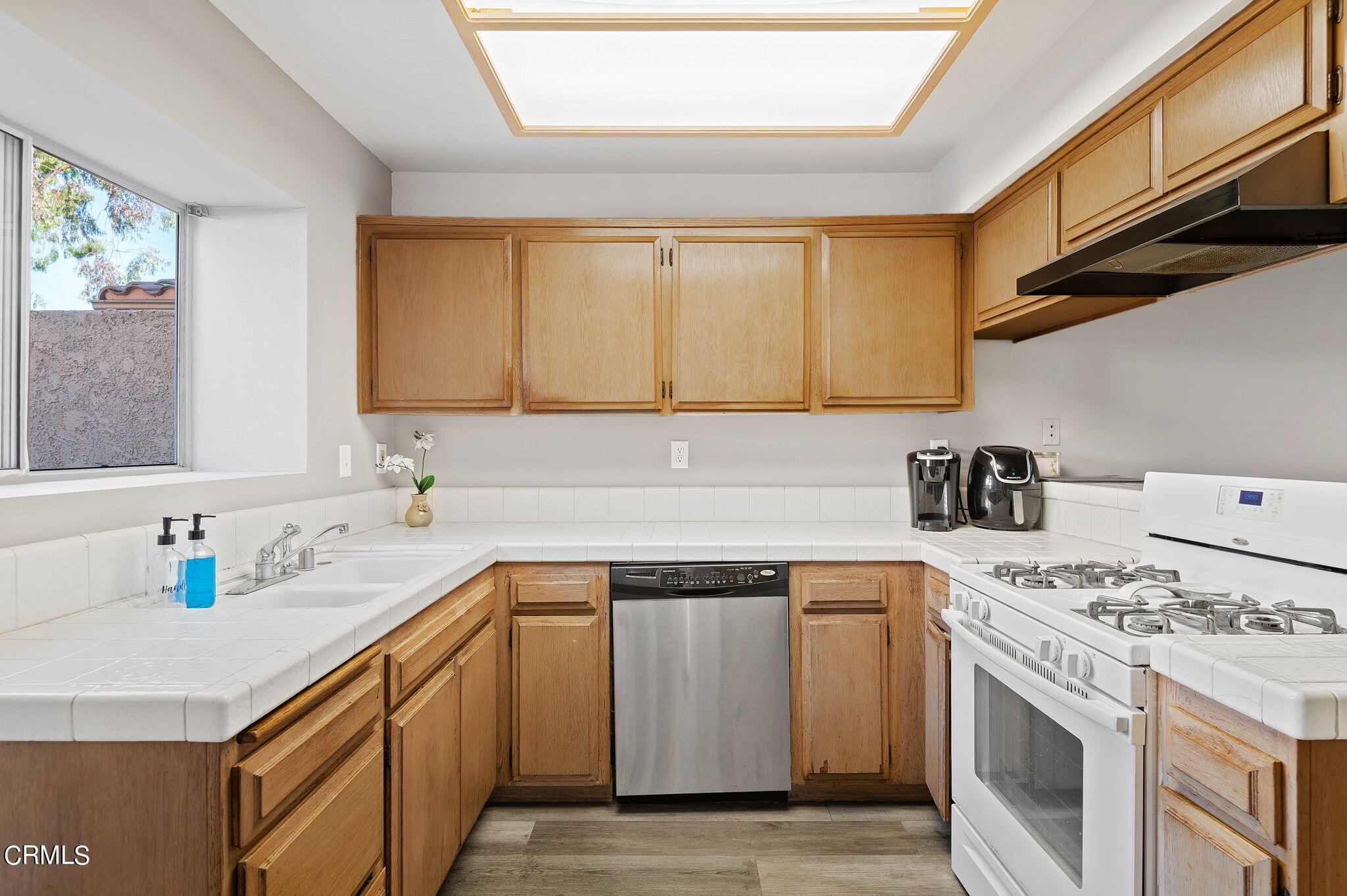 402 Johnson Road Oxnard, CA 93033 - Photo 8 of 18 a kitchen with a sink stove top oven and cabinets