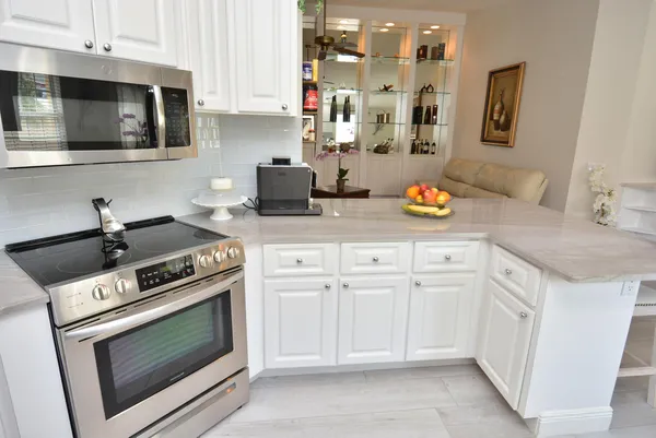 a kitchen with cabinets appliances and a sink