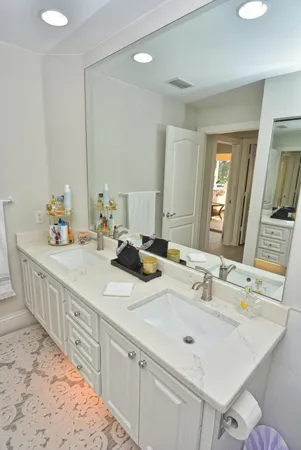 a bathroom with a sink double vanity and a mirror
