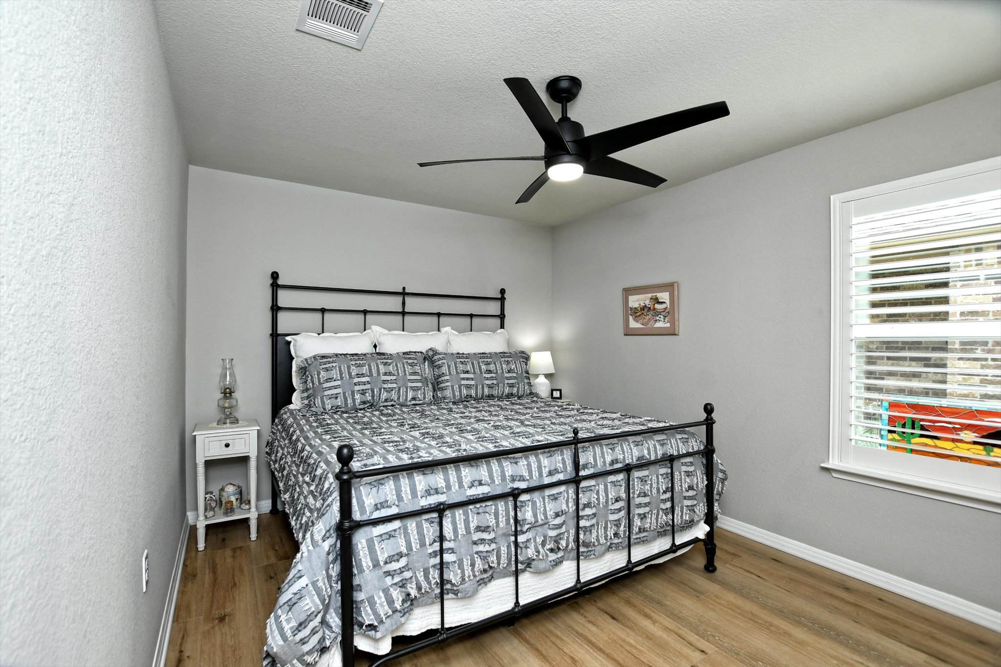 231 Hobby Street Georgetown, TX 78633 - Photo 22 of 29 Hardwood-style flooring and a window with blinds provide a cozy and functional atmosphere.