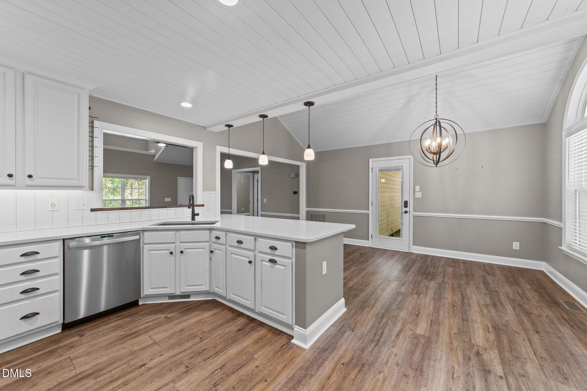 6820 Oviedo Drive Raleigh, NC 27603 - Photo 10 of 50 a open kitchen with stainless steel appliances granite countertop a dishwasher a stove and white cabinets with wooden floor