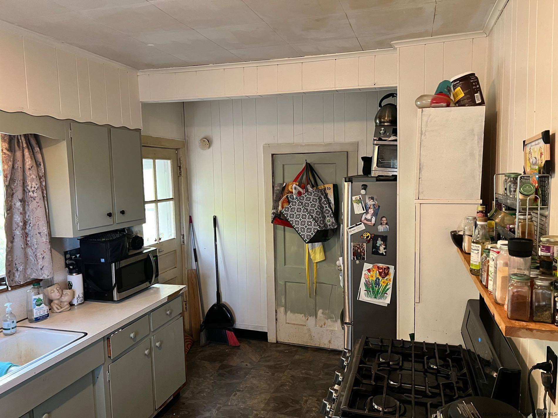 87 Dewitt Street Kingston, NY 12401 - Photo 18 of 33 a view of a kitchen with fridge and workspace