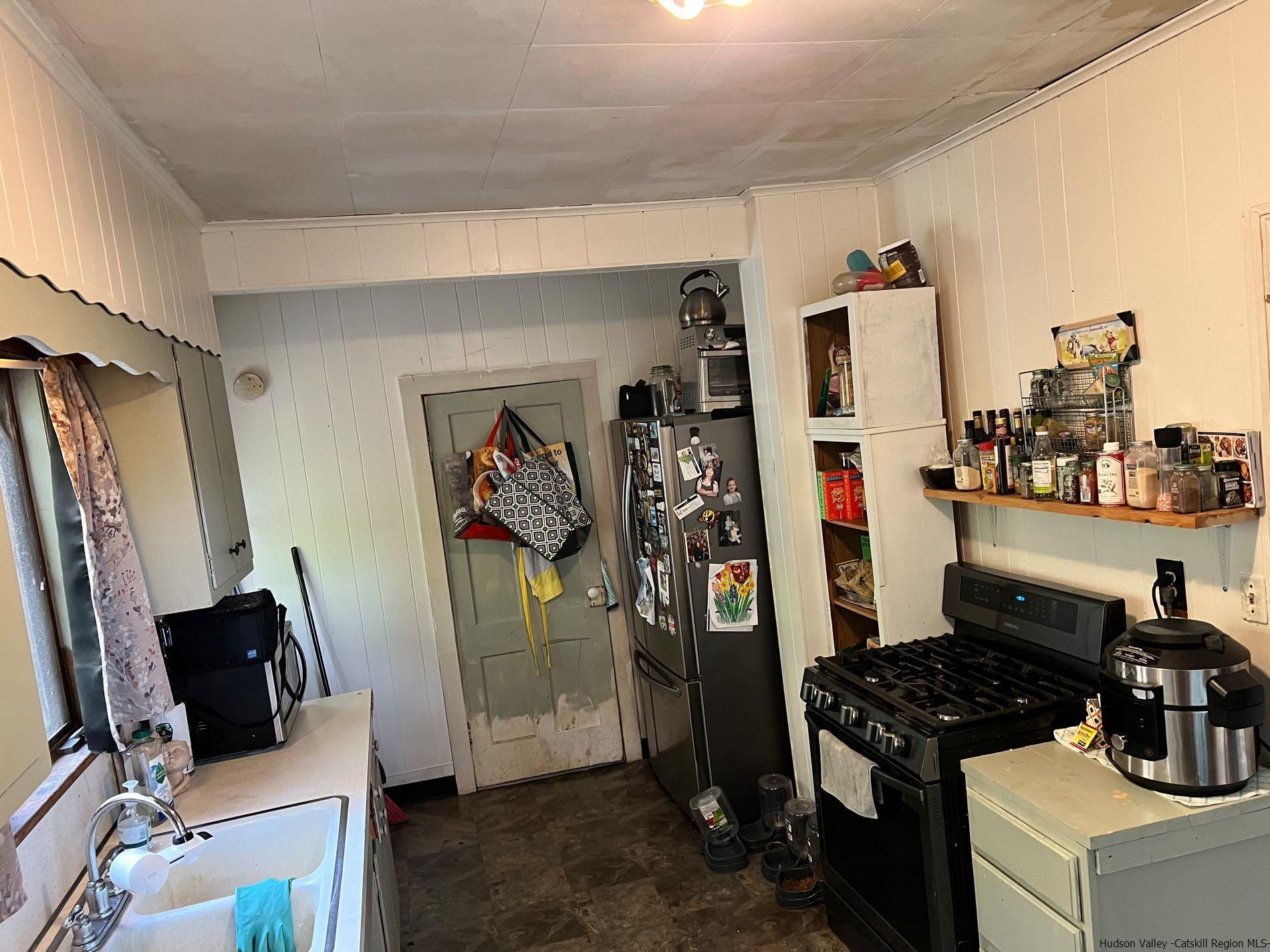 87 Dewitt Street Kingston, NY 12401 - Photo 20 of 33 a kitchen with a refrigerator and a stove