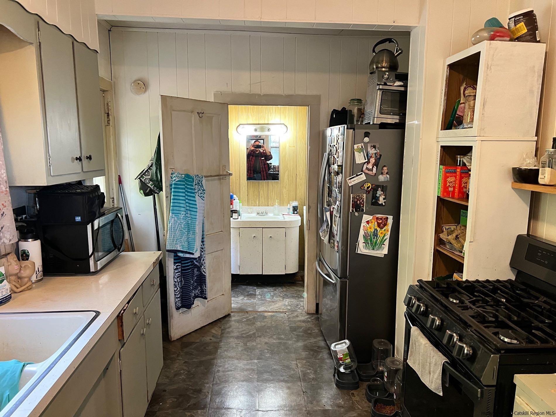 87 Dewitt Street Kingston, NY 12401 - Photo 21 of 33 a kitchen with a refrigerator and a stove