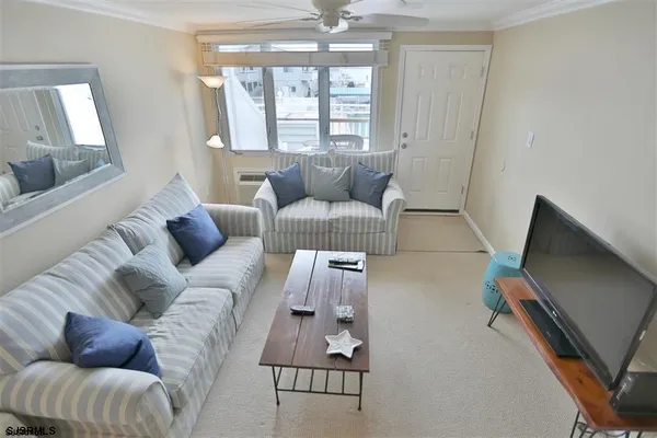 a living room with furniture and a flat screen tv