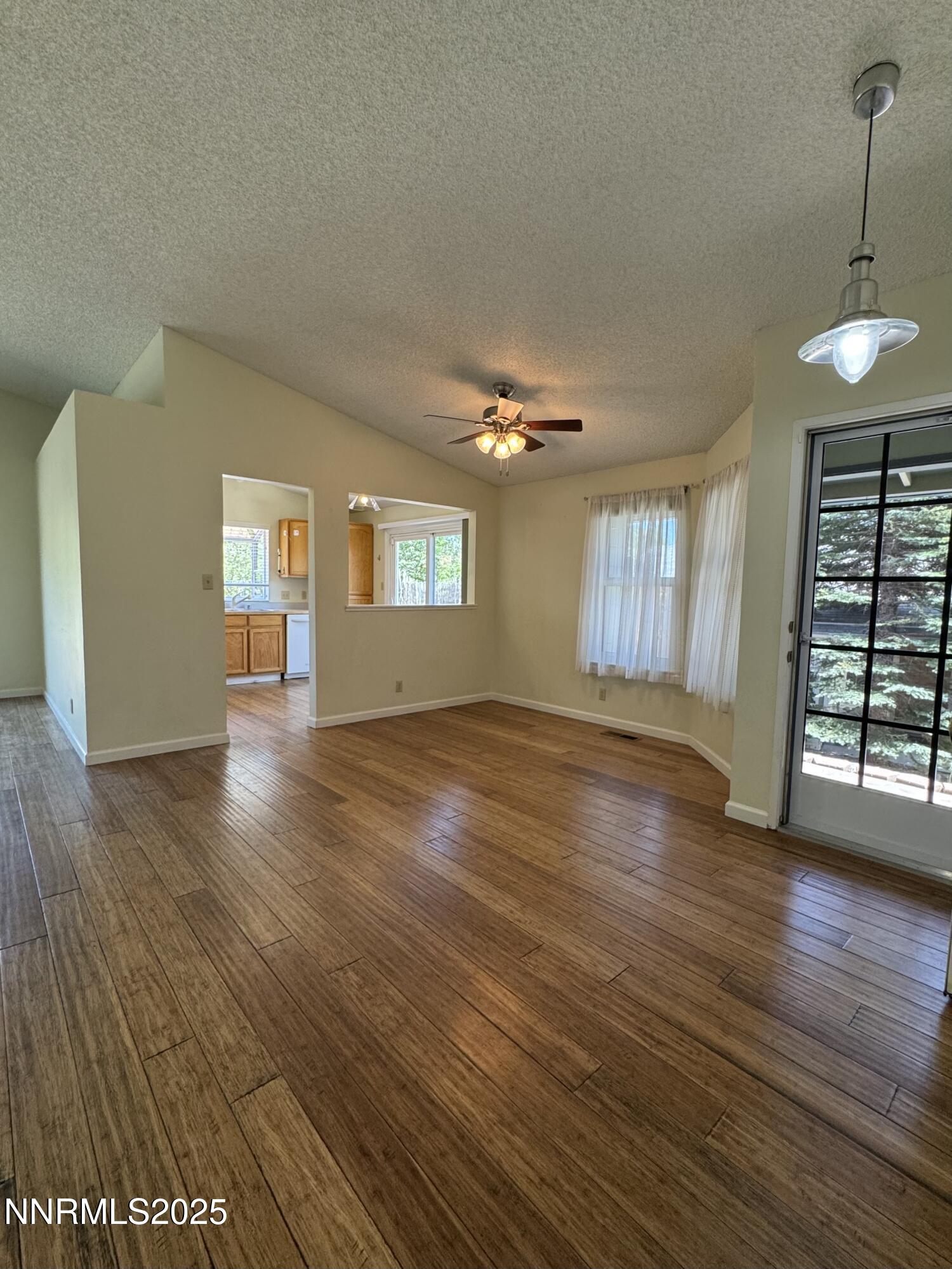 6559 Fall River Circle Reno, NV 89523 - Photo 6 of 35 an empty room with wooden floor and windows