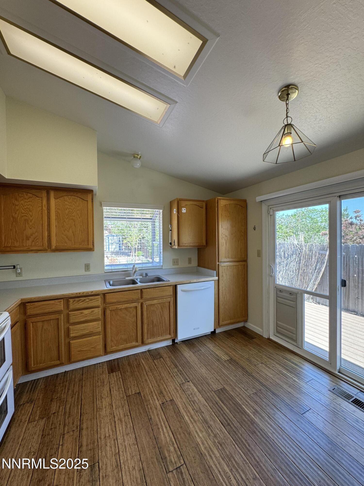 6559 Fall River Circle Reno, NV 89523 - Photo 7 of 35 a kitchen with stainless steel appliances granite countertop a sink a stove cabinets and wooden floor