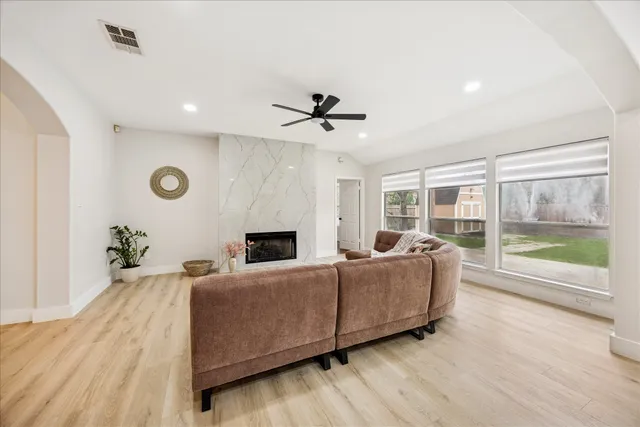 a living room with furniture and a floor to ceiling window