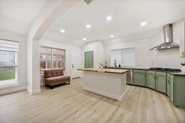 a kitchen with stainless steel appliances granite countertop a sink and cabinets