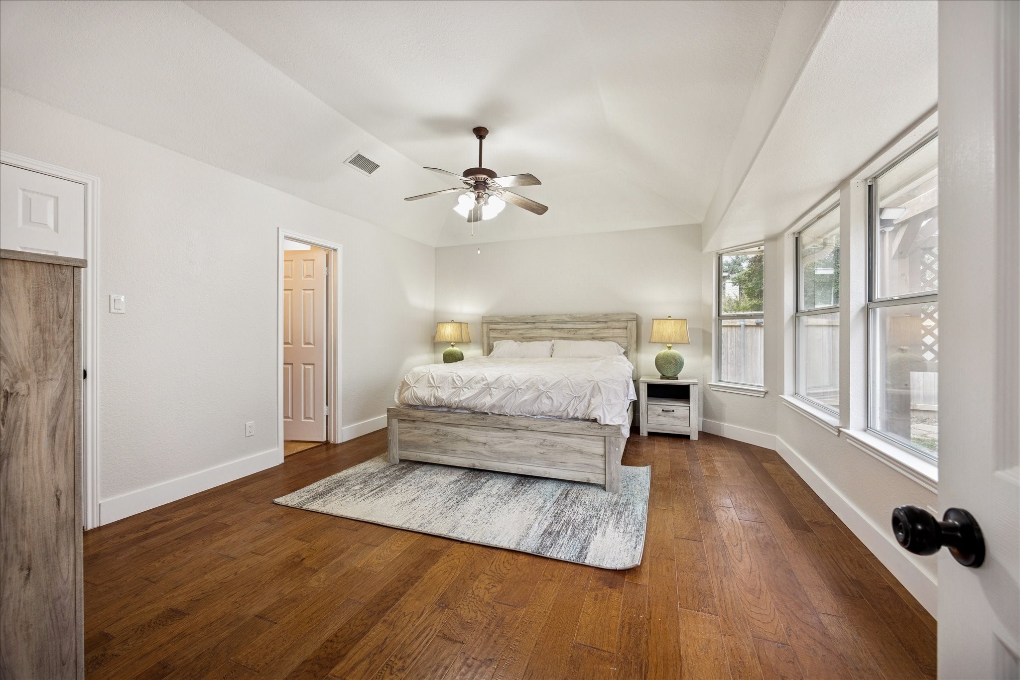12624 Twisted Briar Lane Austin, TX 78729 - Photo 21 of 41 a bedroom with a bed and wooden floor