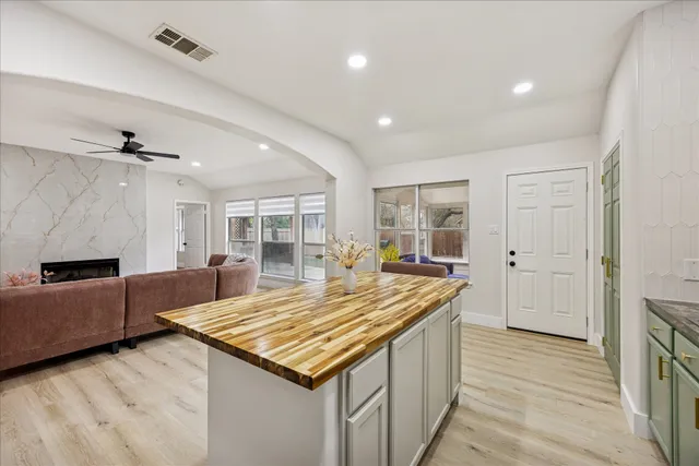 a living room with kitchen island furniture and a wooden floor