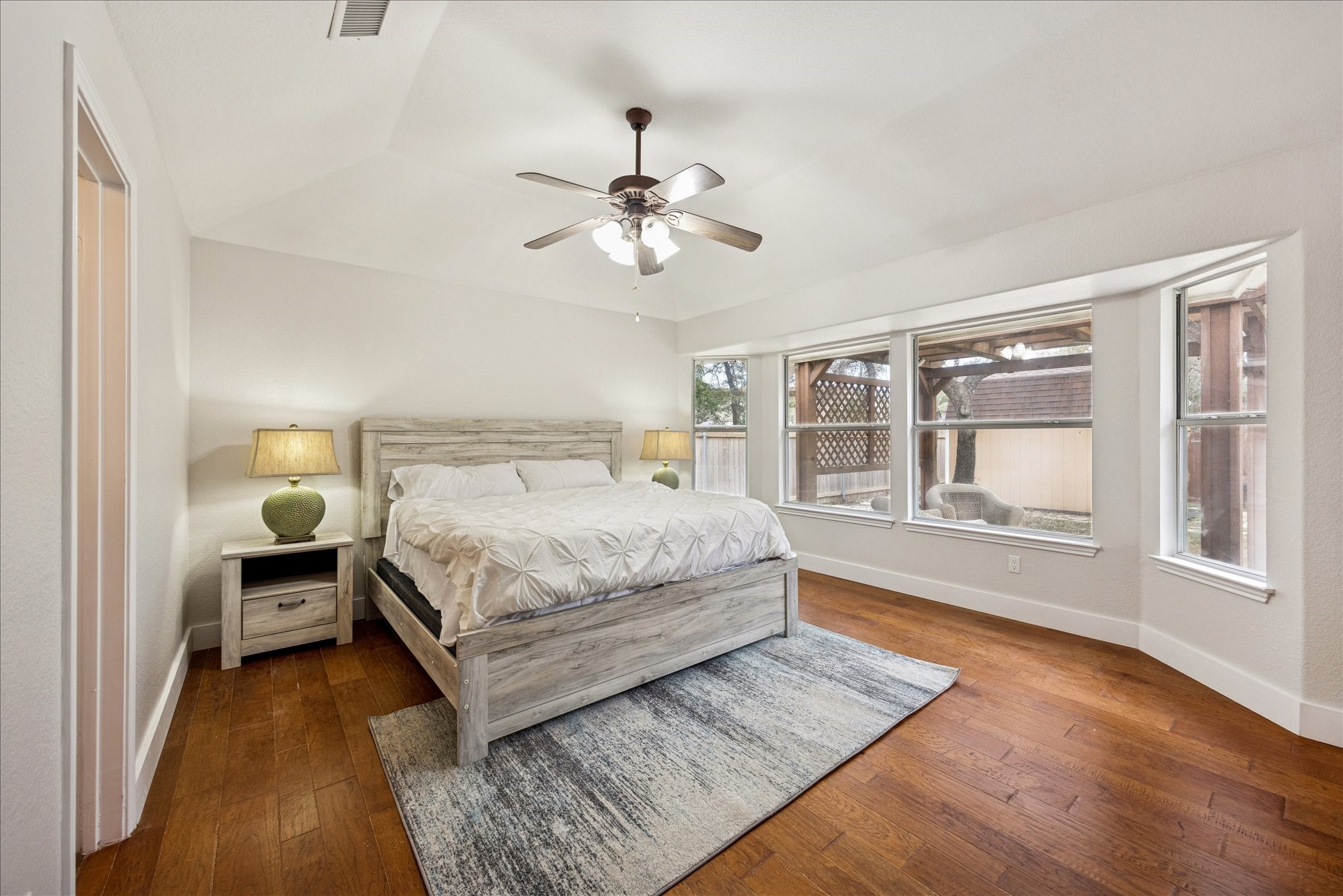 12624 Twisted Briar Lane Austin, TX 78729 - Photo 22 of 41 a bedroom with a large bed and a chandelier