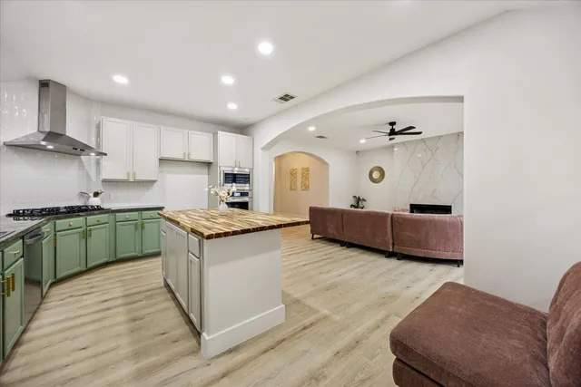 a kitchen with stainless steel appliances granite countertop a stove and a sink