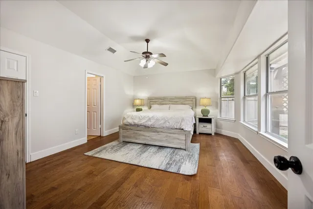 a bedroom with a bed and wooden floor