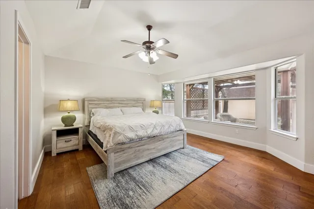 a bedroom with a large bed and a chandelier