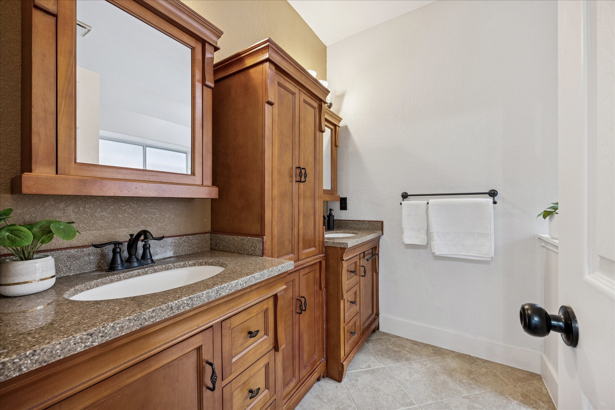 12624 Twisted Briar Lane Austin, TX 78729 - Photo 24 of 41 a bathroom with a granite countertop sink a mirror and shower