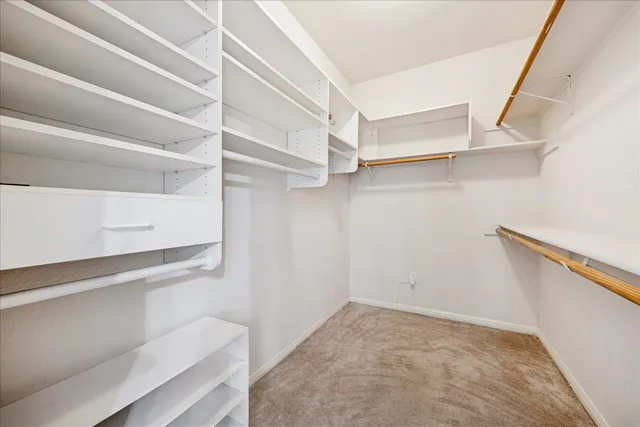 a view of walk in closet with empty racks
