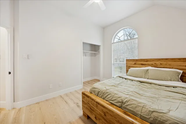 a bedroom with a bed and a window