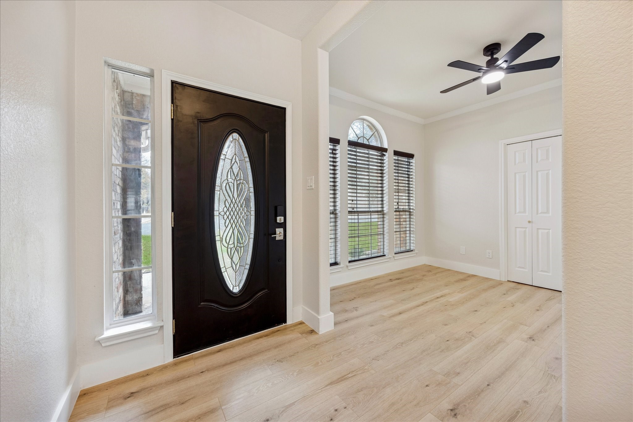 12624 Twisted Briar Lane Austin, TX 78729 - Photo 3 of 41 a view of a livingroom with wooden floor a ceiling fan and windows