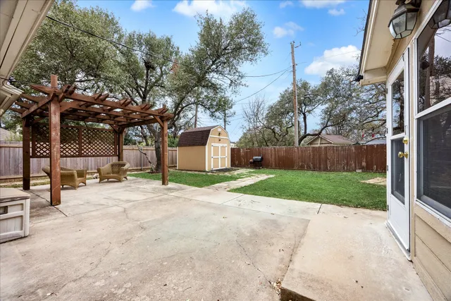 a view of a yard with plants and tree