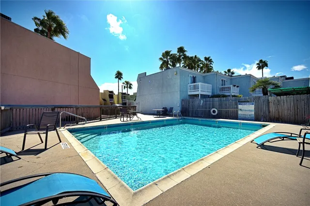 swimming pool view with a seating space
