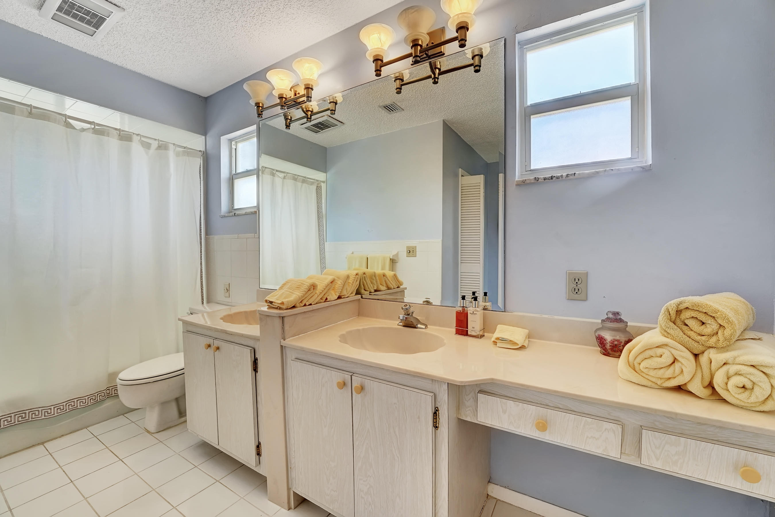 16 Sailfish Lane Ocean Ridge, FL 33435 - Photo 22 of 37 a bathroom with a sink a toilet and a mirror