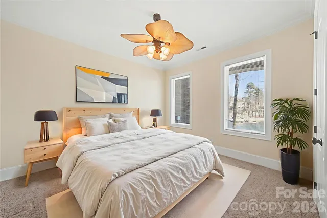 a bedroom with a bed and a chandelier