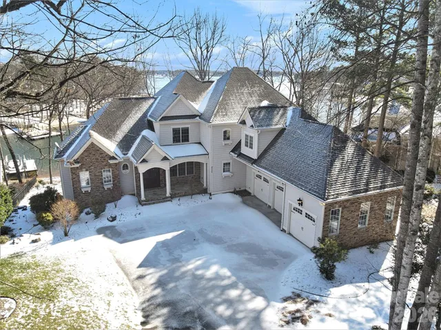 a view of a house with a yard covered in snow