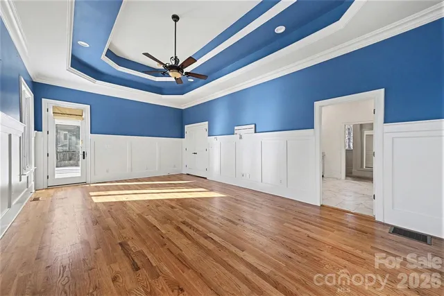 a view of empty room with wooden floor