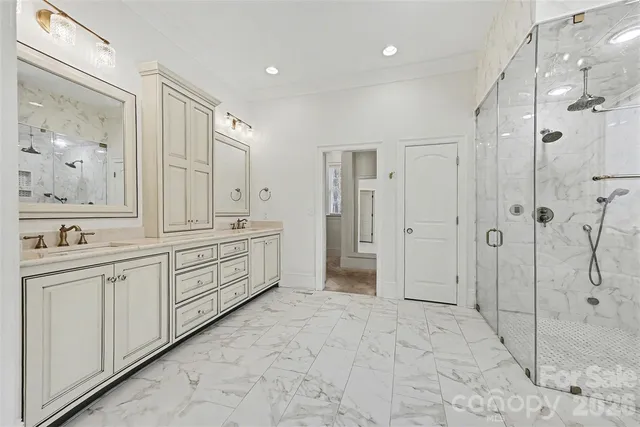 a spacious bathroom with a shower sink and mirror