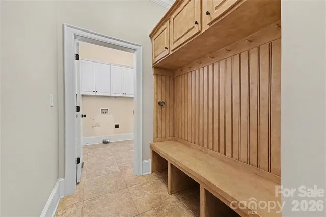 a kitchen with granite countertop white cabinets and a sink