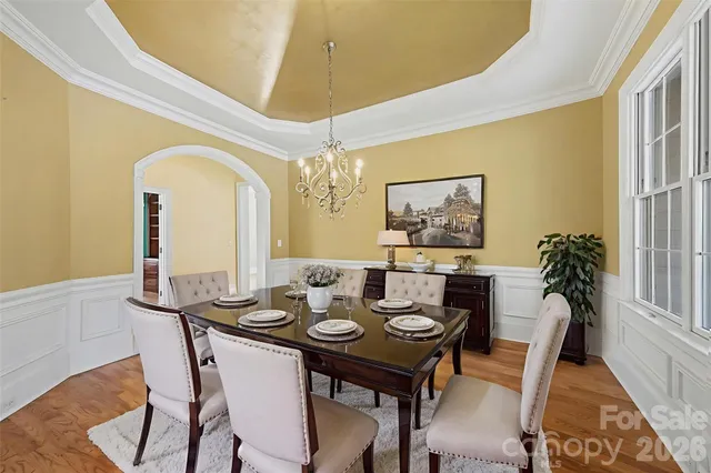 a view of a dining room with furniture and a potted plant