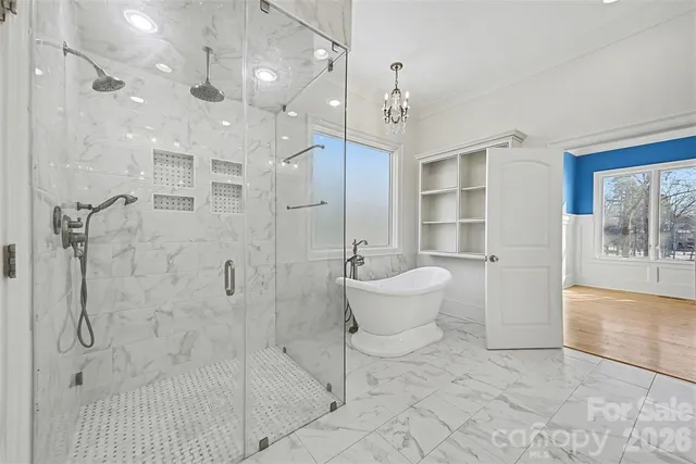 a spacious bathroom with a bathtub shower sink and mirror