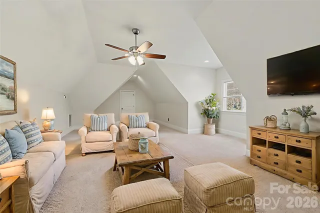a living room with furniture a flat screen tv and a window