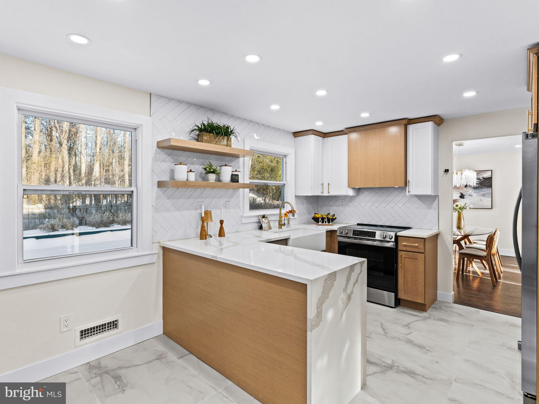 7 Charter Oak Road Clementon, NJ 08021 - Photo 15 of 48 a kitchen with stainless steel appliances granite countertop a stove top oven a sink a dining table and chairs