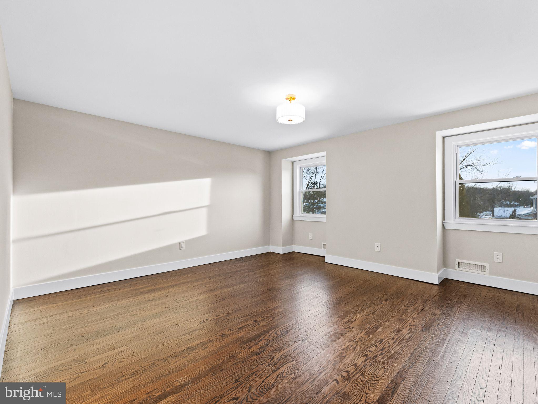 7 Charter Oak Road Clementon, NJ 08021 - Photo 30 of 48 an empty room with wooden floor and windows