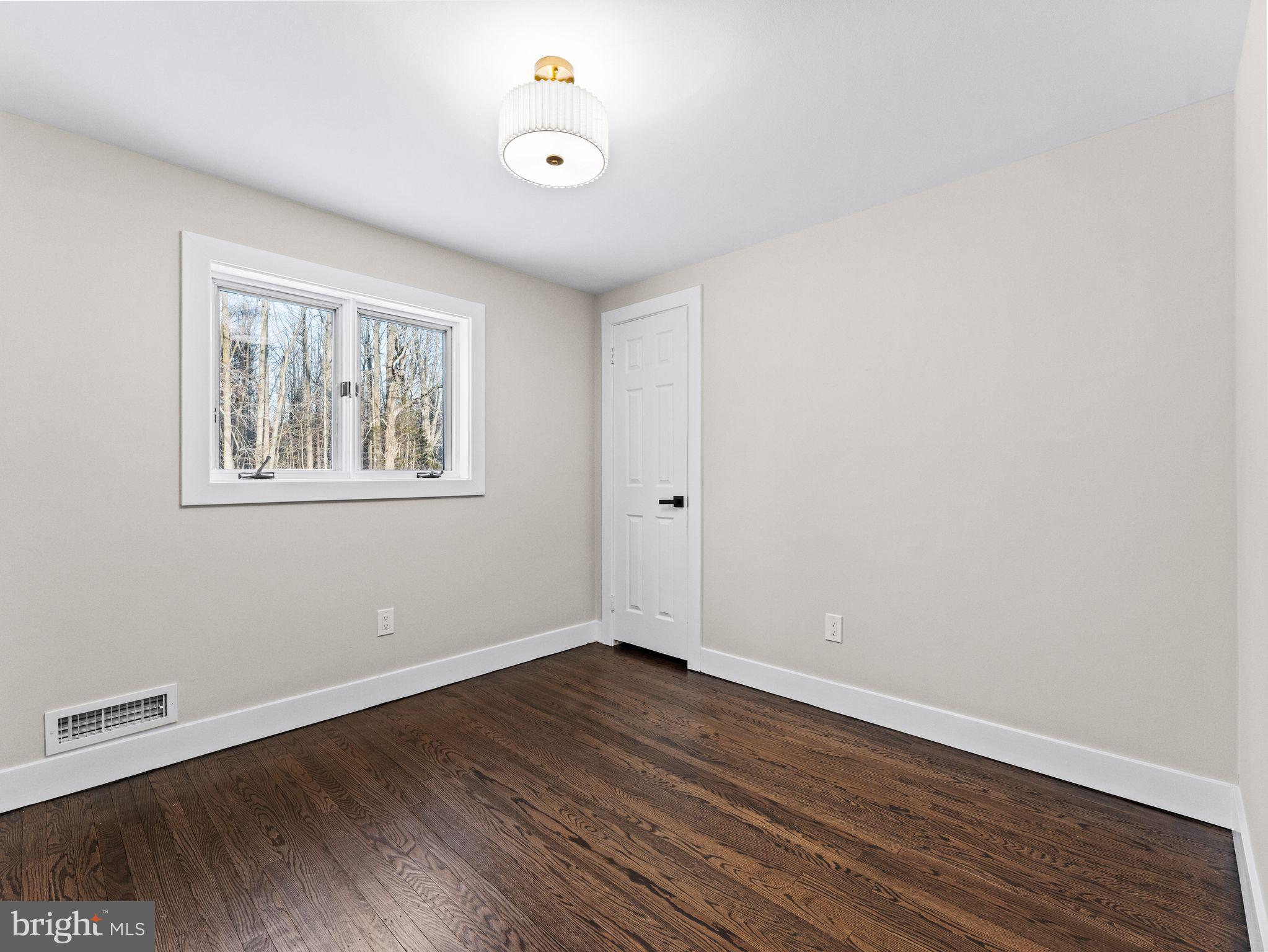 7 Charter Oak Road Clementon, NJ 08021 - Photo 33 of 48 an empty room with wooden floor and windows