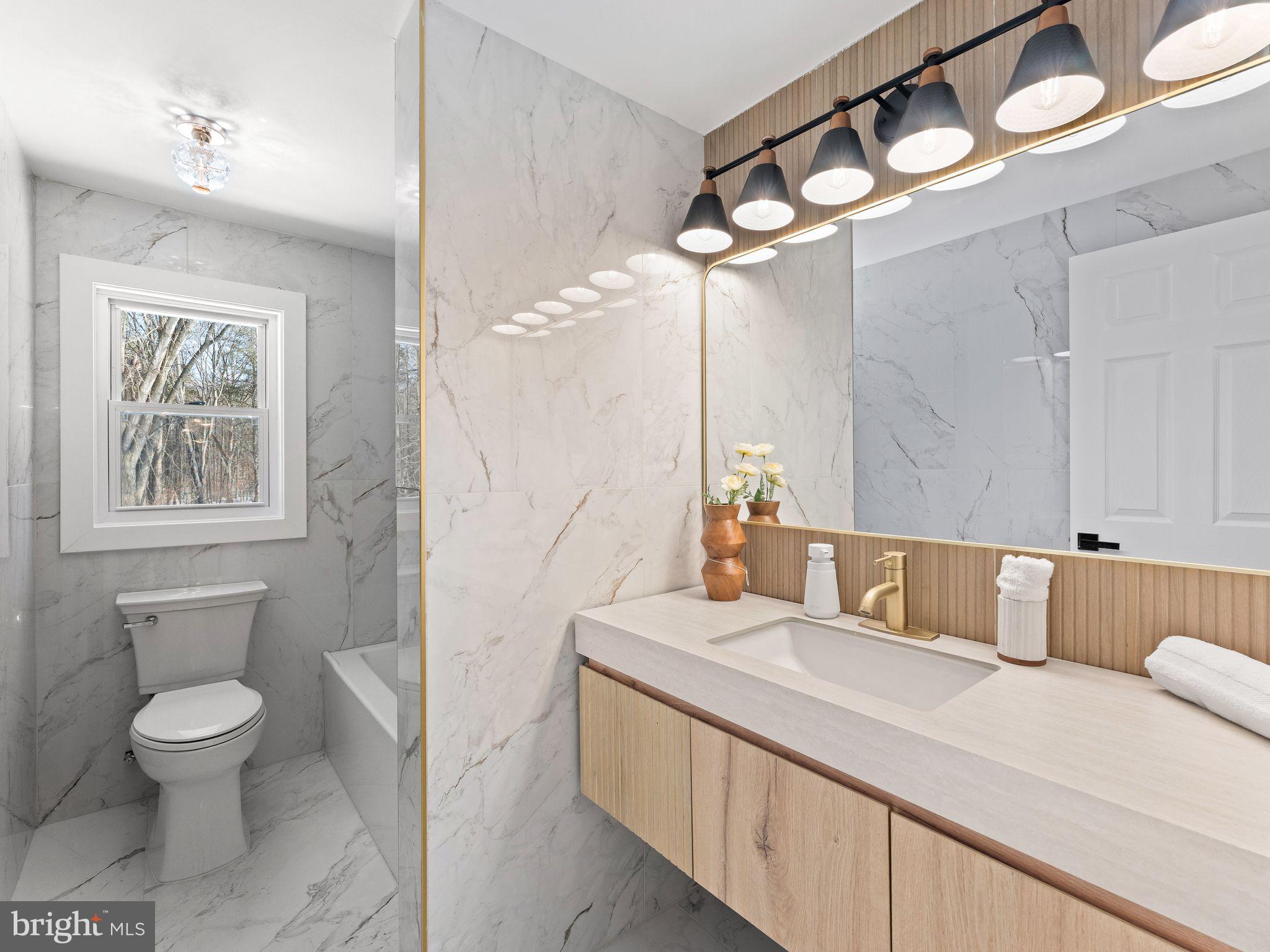 7 Charter Oak Road Clementon, NJ 08021 - Photo 35 of 48 a bathroom with a sink a toilet and a mirror