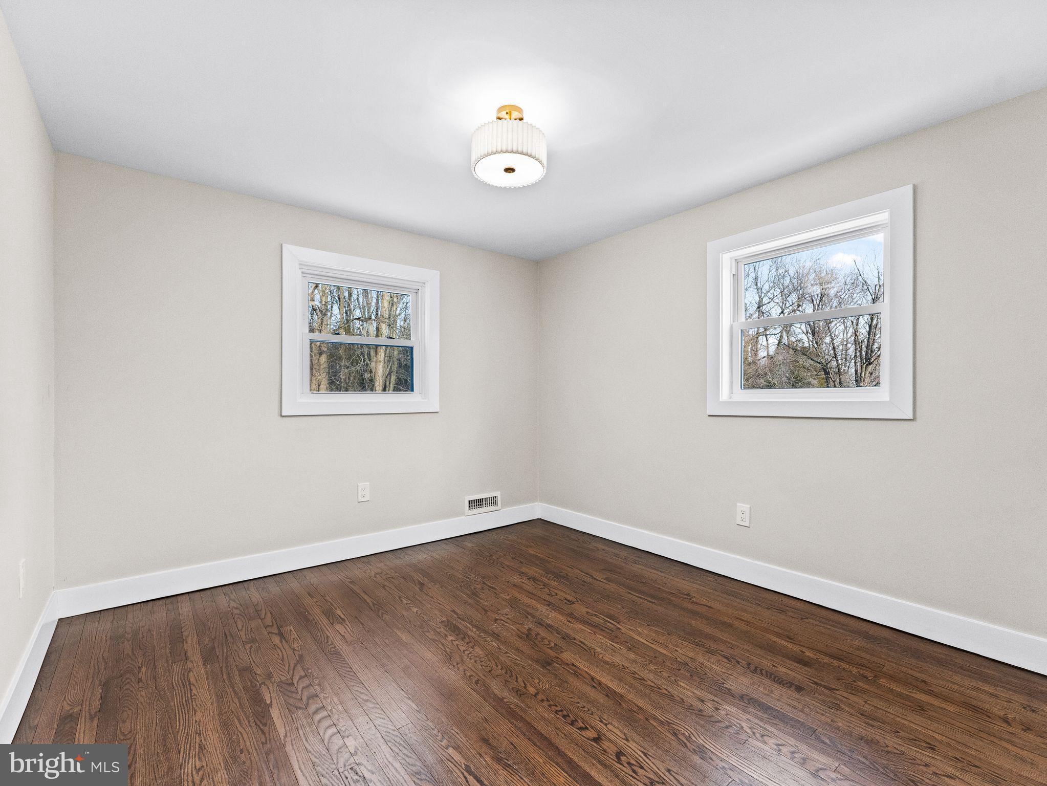 7 Charter Oak Road Clementon, NJ 08021 - Photo 40 of 48 a view of an empty room with wooden floor and a window