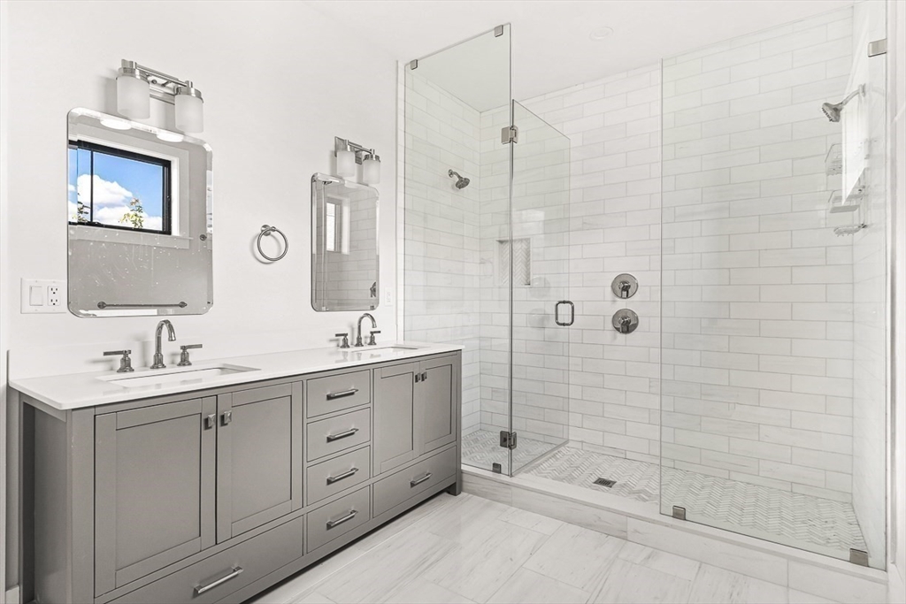 65 Summer Street, Unit 1 Natick, MA 01760 - Photo 12 of 21 a bathroom with a shower sink and mirror