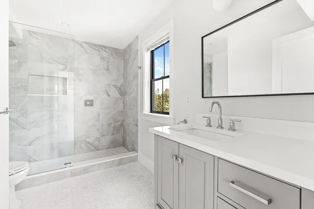 a view of a hallway with wooden floor and windows
