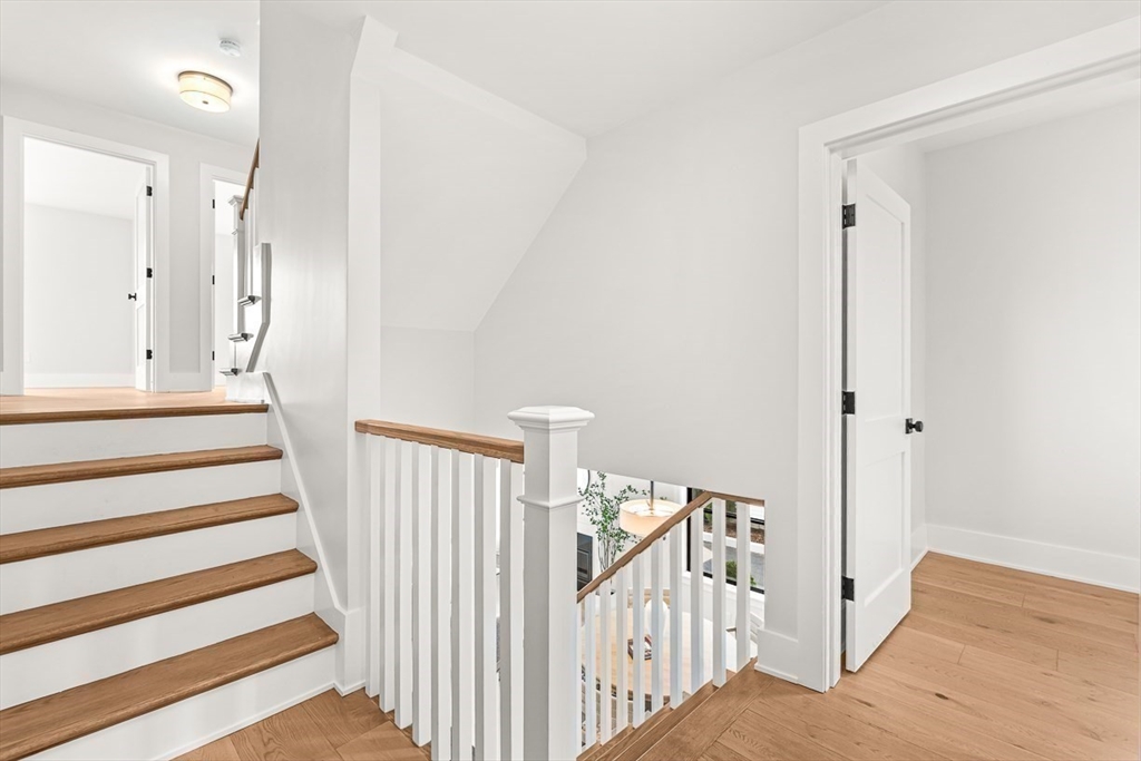 65 Summer Street, Unit 1 Natick, MA 01760 - Photo 15 of 21 a view of a hallway with wooden floor and windows