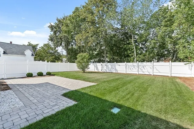 a view of a house with garage and plants