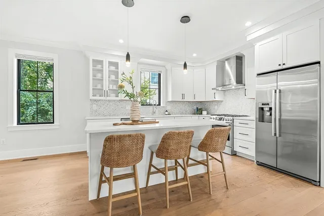 a kitchen with white cabinets and stainless steel appliances