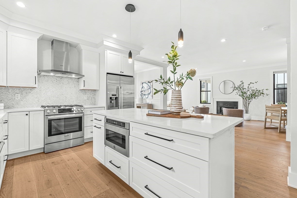 65 Summer Street, Unit 1 Natick, MA 01760 - Photo 7 of 21 a kitchen with a stove and white cabinets